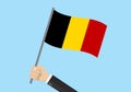 Belgium waving flag. Hand holding Belgian flag. National symbol. Vector illustration Royalty Free Stock Photo